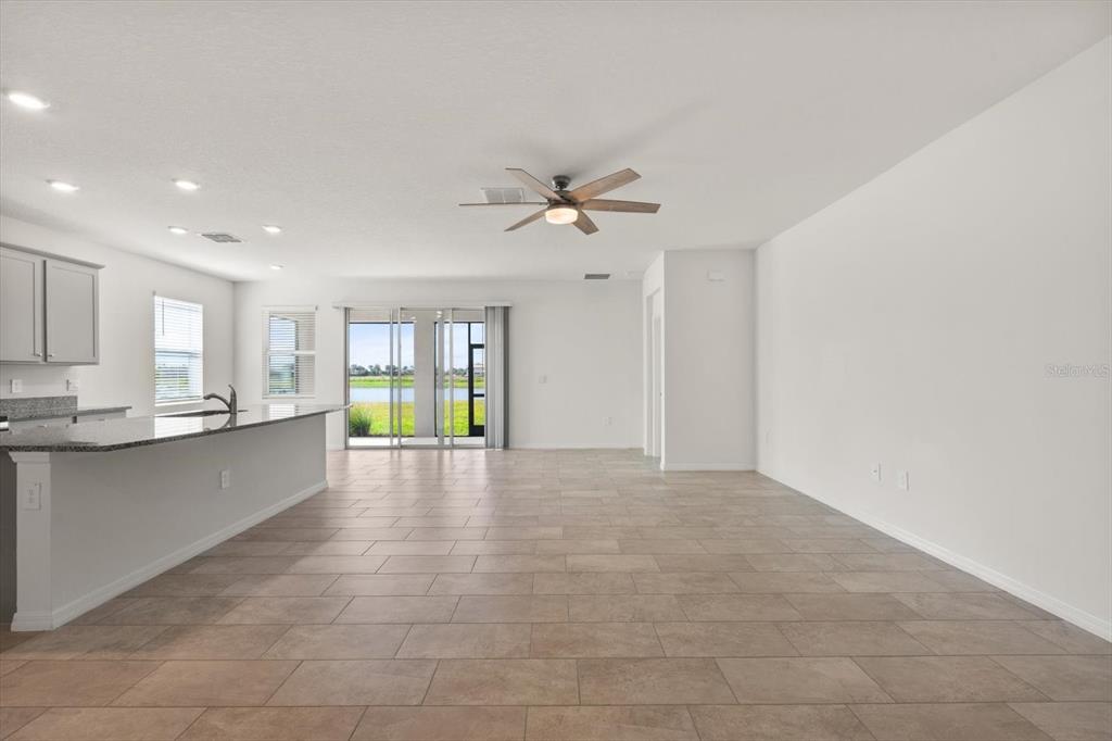 17738 Pastureland Avenue Lakewood Ranch, FL 34211 - Photo 11 of 50 a view of an empty room with a kitchen