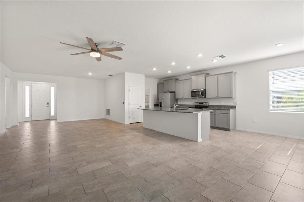 17738 Pastureland Avenue Lakewood Ranch, FL 34211 - Photo 12 of 50 a view of kitchen with kitchen island stainless steel appliances sink cabinets and window