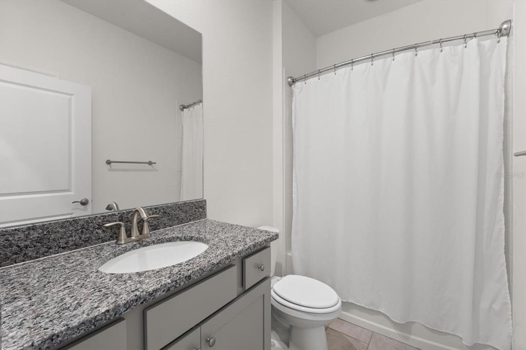 17738 Pastureland Avenue Lakewood Ranch, FL 34211 - Photo 22 of 50 a bathroom with a granite countertop sink and a mirror
