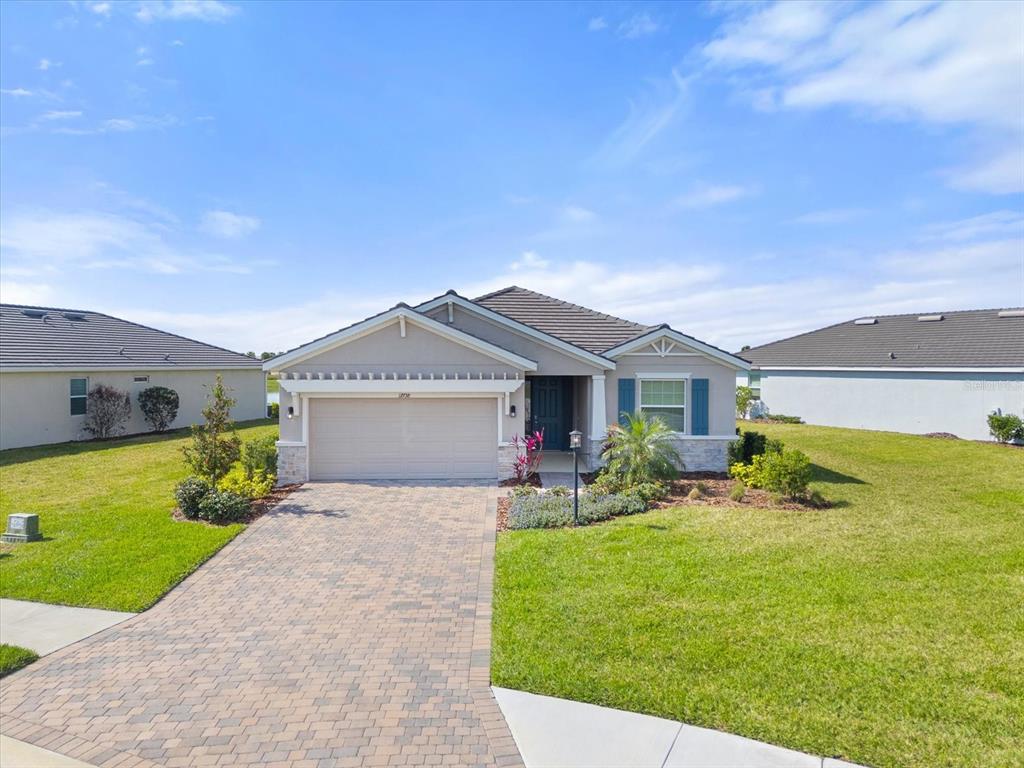 17738 Pastureland Avenue Lakewood Ranch, FL 34211 - Photo 29 of 50 a front view of a house with garden