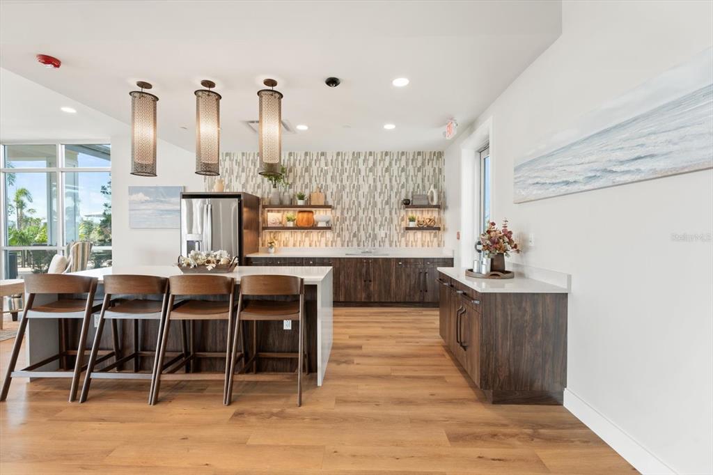 17738 Pastureland Avenue Lakewood Ranch, FL 34211 - Photo 41 of 50 a view of a kitchen with kitchen island granite countertop wooden floor and chairs