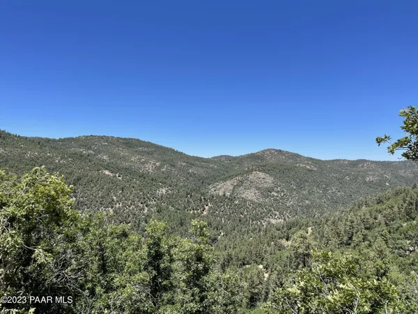 a view of a mountain range in a cloudy sky