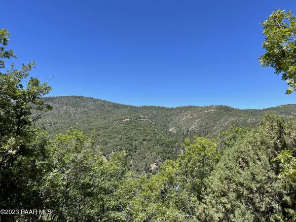 a view of a large mountain with mountains in the background