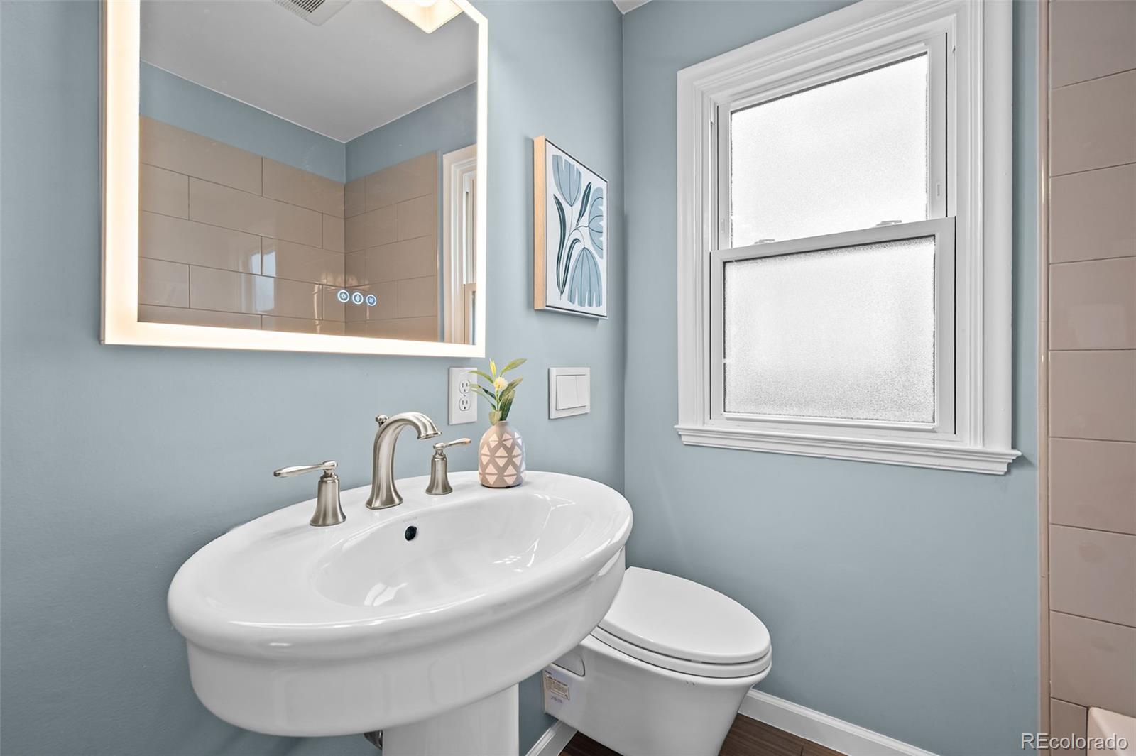 2344 South Lafayette Street Denver, CO 80210 - Photo 14 of 32 a bathroom with a sink and a toilet