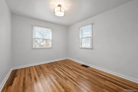 a view of room with window and wooden floor
