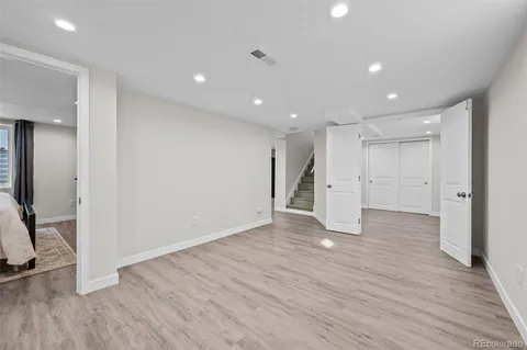 a view of empty room with wooden floor