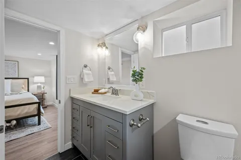 a bathroom with a sink toilet and mirror