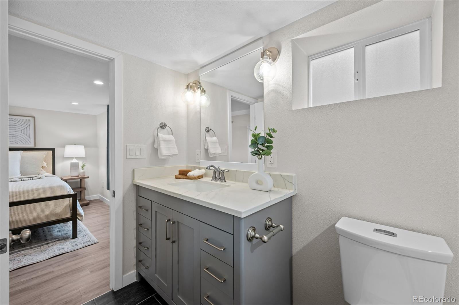 2344 South Lafayette Street Denver, CO 80210 - Photo 20 of 32 a bathroom with a sink toilet and mirror