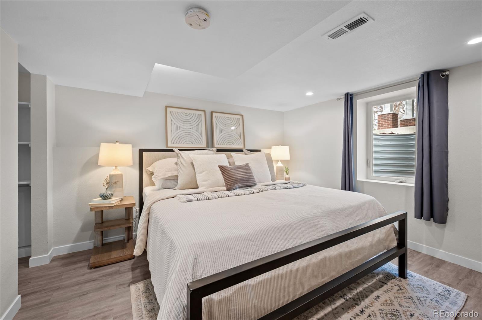 2344 South Lafayette Street Denver, CO 80210 - Photo 22 of 32 a bedroom with a bed and wooden floor