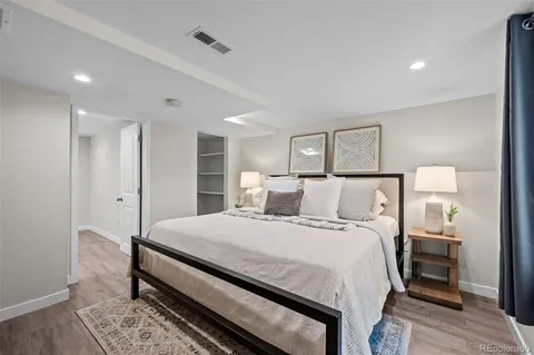 a bedroom with a bed and a night stand