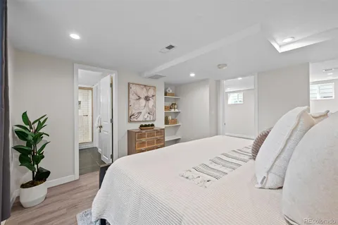 a bedroom with a large bed and a potted plant