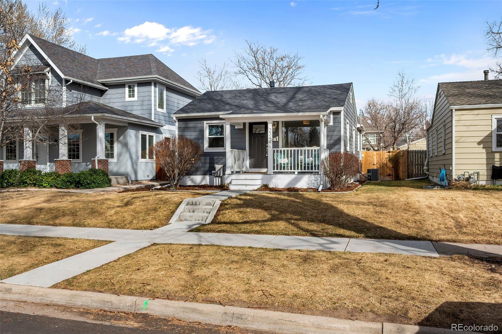 2344 South Lafayette Street Denver, CO 80210 - Photo 3 of 32 a front view of a house with a yard table and chairs