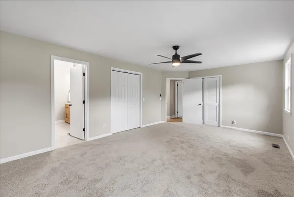 a view of an empty room with a ceiling fan