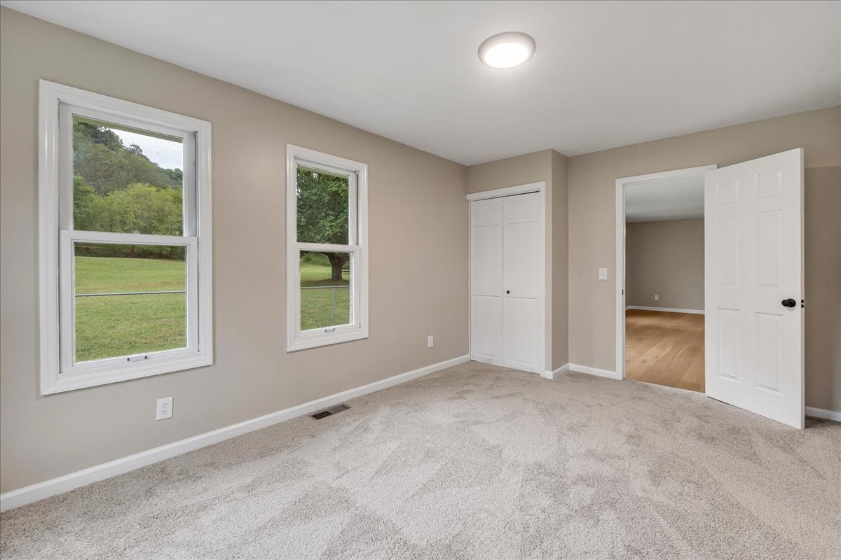 315 Little Creek Road Pleasant Shade, TN 37145 - Photo 20 of 32 an empty room with windows and closet