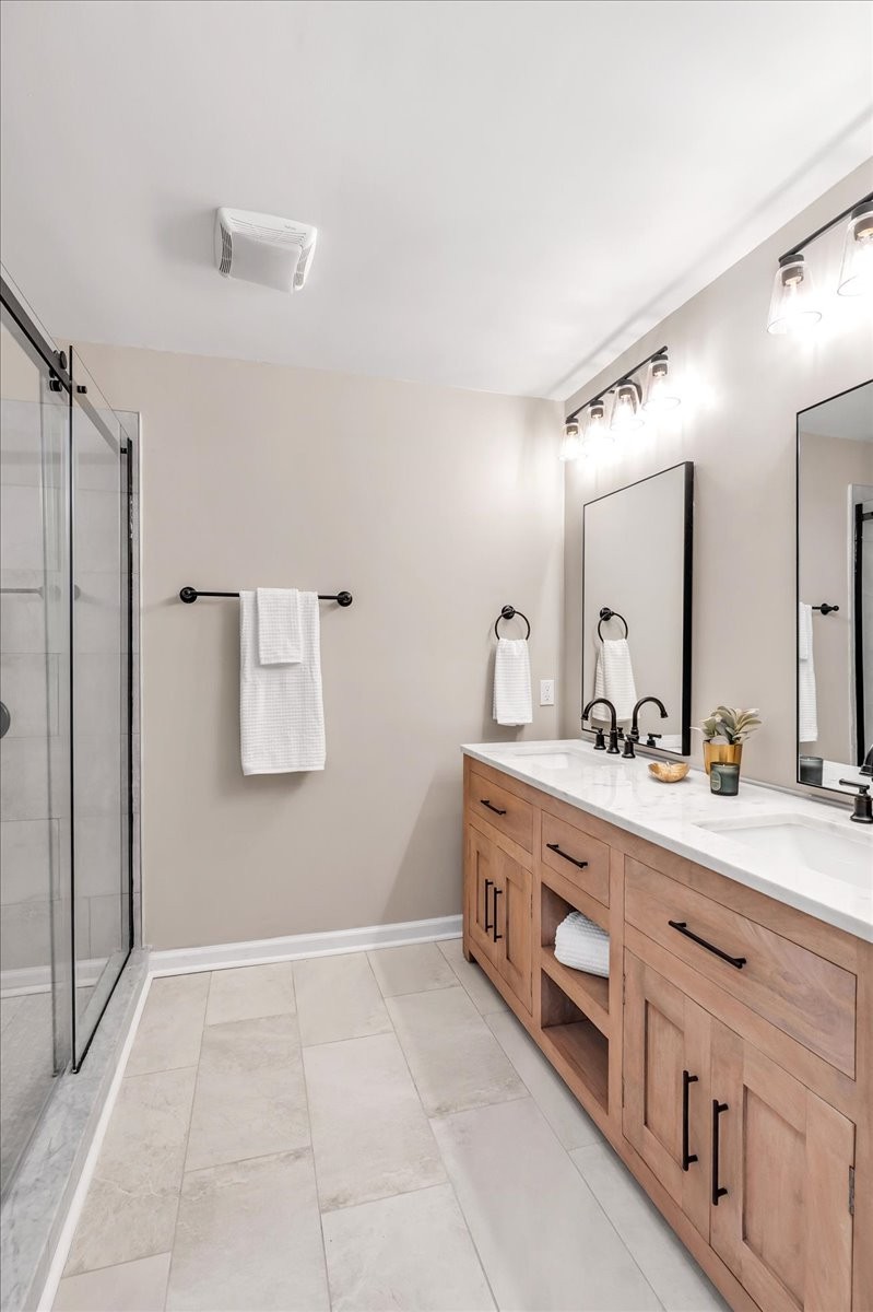 315 Little Creek Road Pleasant Shade, TN 37145 - Photo 2 of 32 a spacious bathroom with a double vanity sink a mirror and a shower