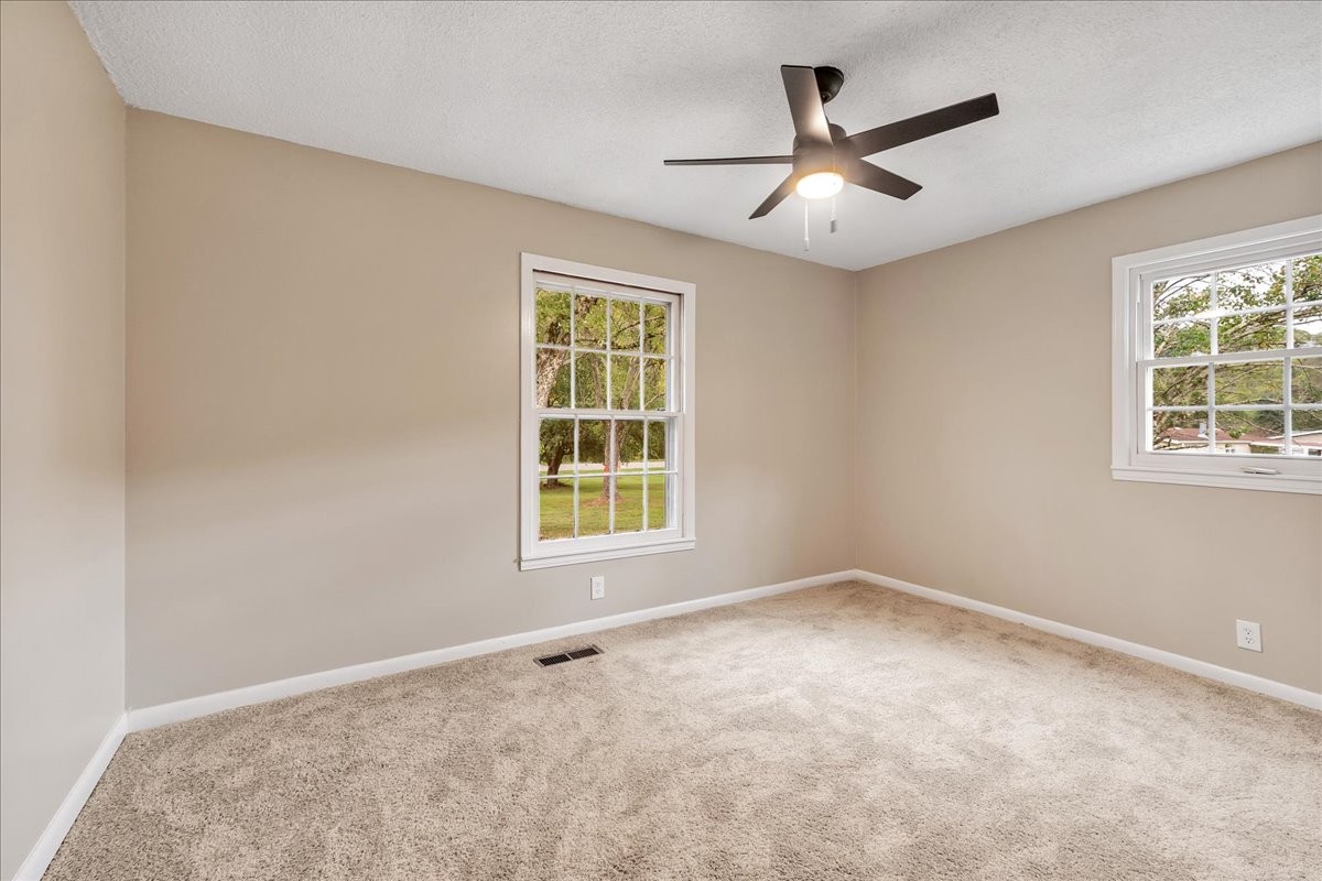 315 Little Creek Road Pleasant Shade, TN 37145 - Photo 21 of 32 an empty room with windows and fan