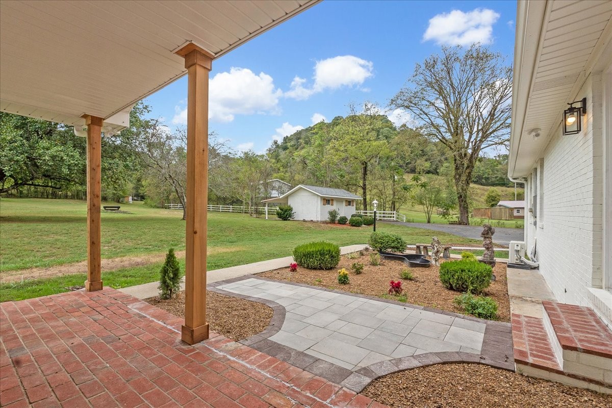 315 Little Creek Road Pleasant Shade, TN 37145 - Photo 32 of 32 a backyard of a house with table and chairs