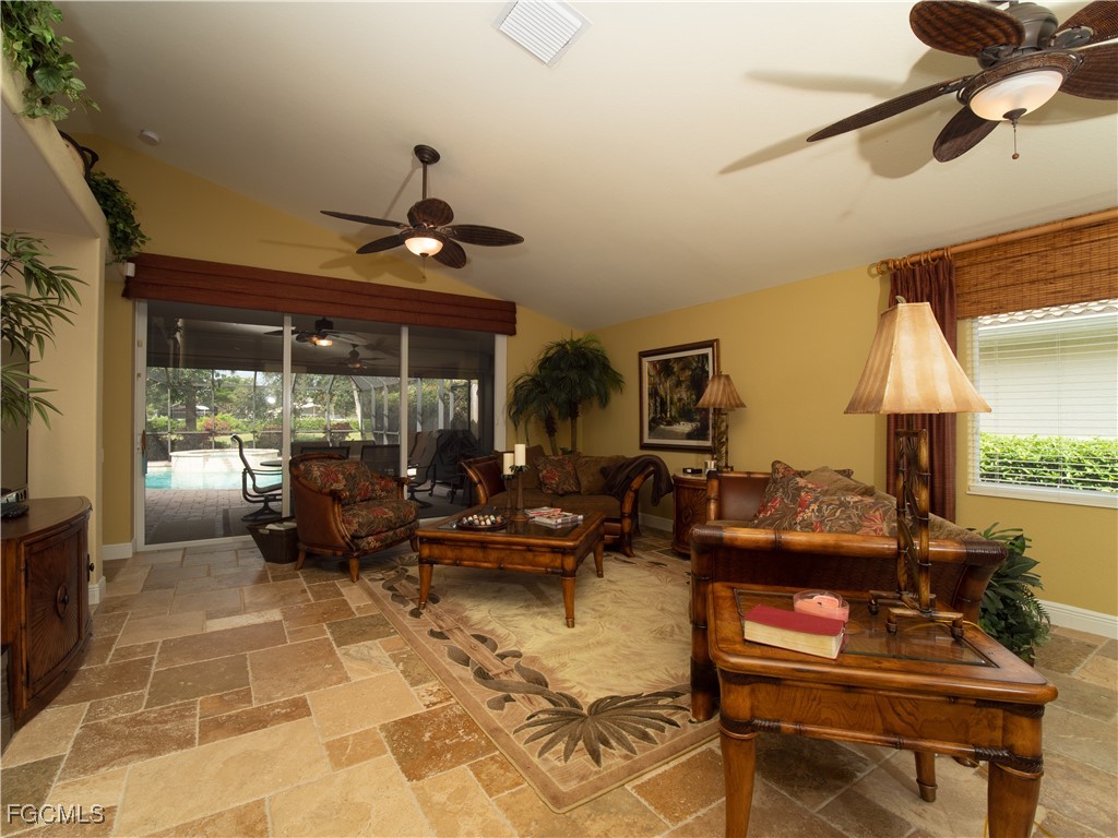 20311 Rookery Drive Estero, FL 33928 - Photo 12 of 29 a living room with fireplace furniture and a large window