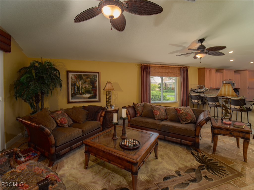 20311 Rookery Drive Estero, FL 33928 - Photo 13 of 29 a living room with furniture a rug and a large window