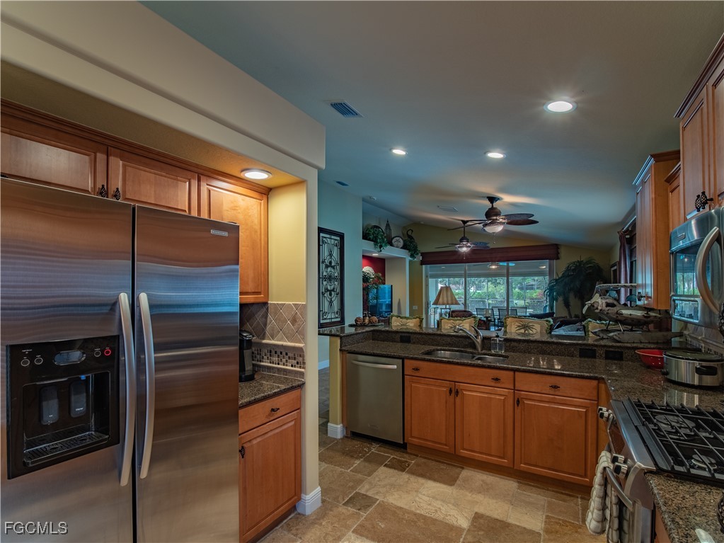 20311 Rookery Drive Estero, FL 33928 - Photo 15 of 29 a kitchen with a sink and stainless steel appliances
