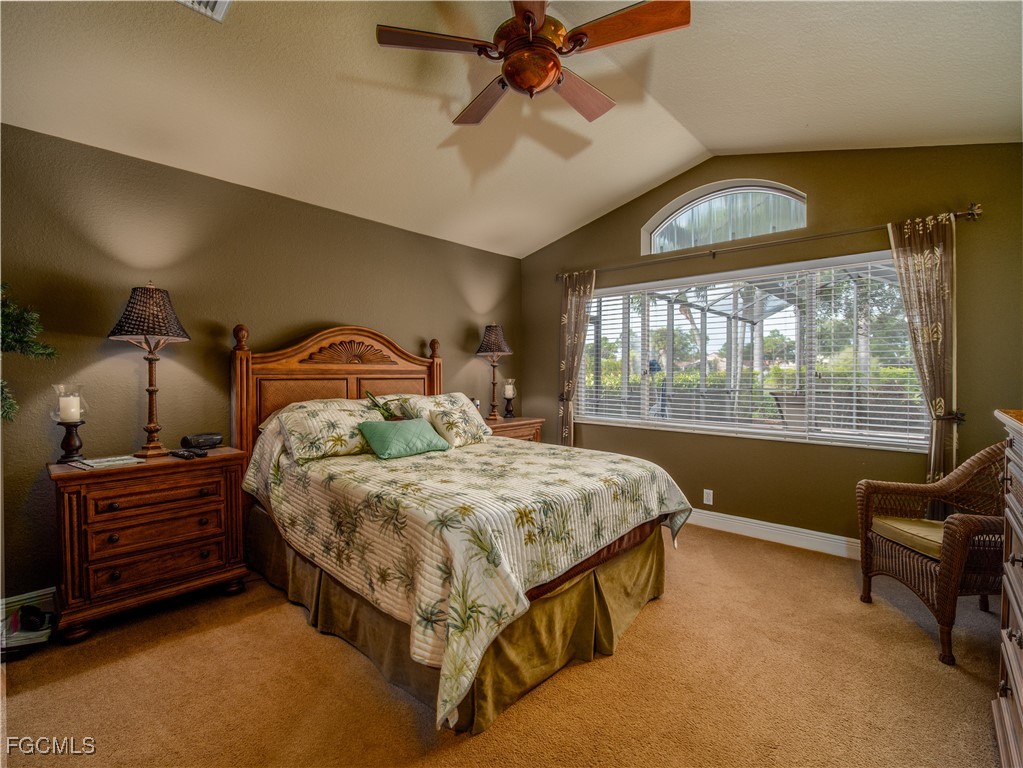 20311 Rookery Drive Estero, FL 33928 - Photo 19 of 29 a bedroom with a bed and a chandelier