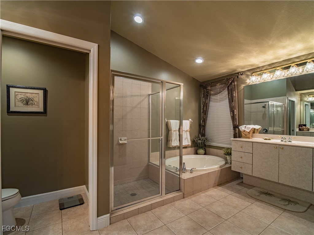 20311 Rookery Drive Estero, FL 33928 - Photo 21 of 29 a bathroom with a double vanity sink toilet and shower