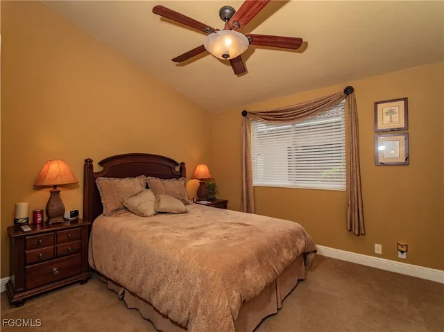 a bathroom with a sink a toilet a mirror a vanity and shower