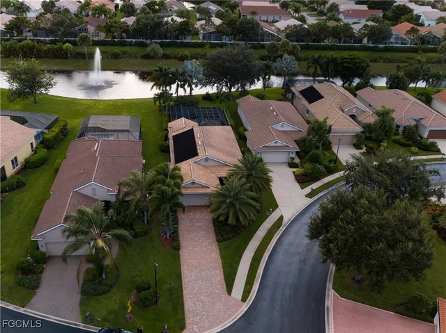 an aerial view of a house with a garden and lake view