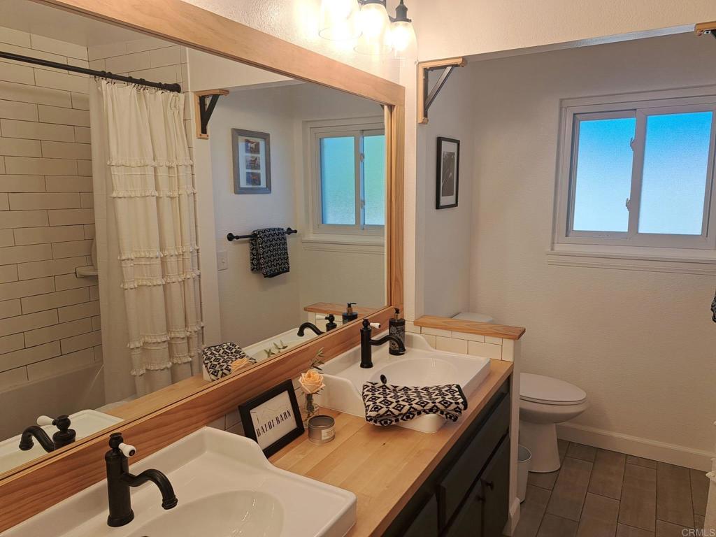 40752 Via De La Roca Fallbrook, CA 92028 - Photo 17 of 37 a bathroom with a sink a toilet and mirror
