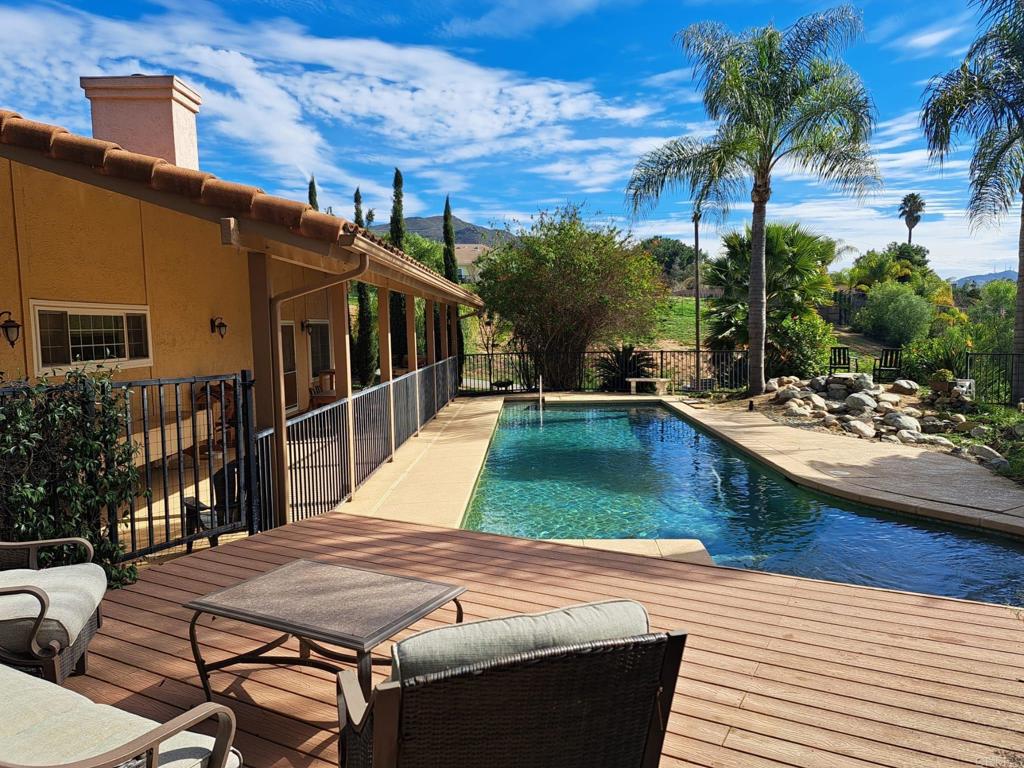 40752 Via De La Roca Fallbrook, CA 92028 - Photo 21 of 37 a view of a patio with table and chairs with wooden floor and fence