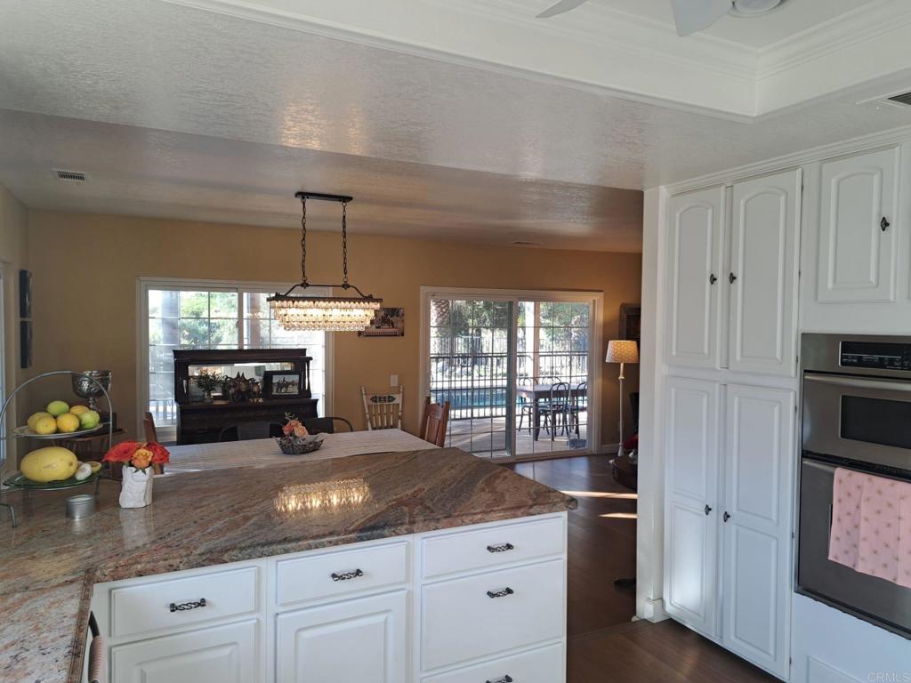 40752 Via De La Roca Fallbrook, CA 92028 - Photo 5 of 37 a kitchen with granite countertop a sink stainless steel appliances and cabinets