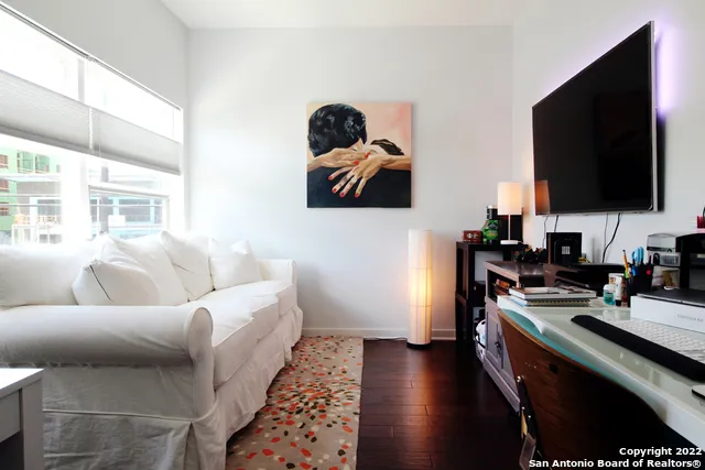 a living room with furniture and a lamp