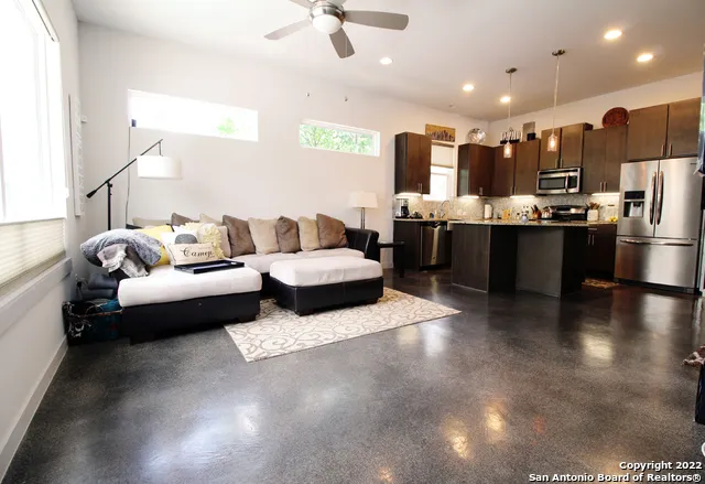 a living room with furniture and kitchen view