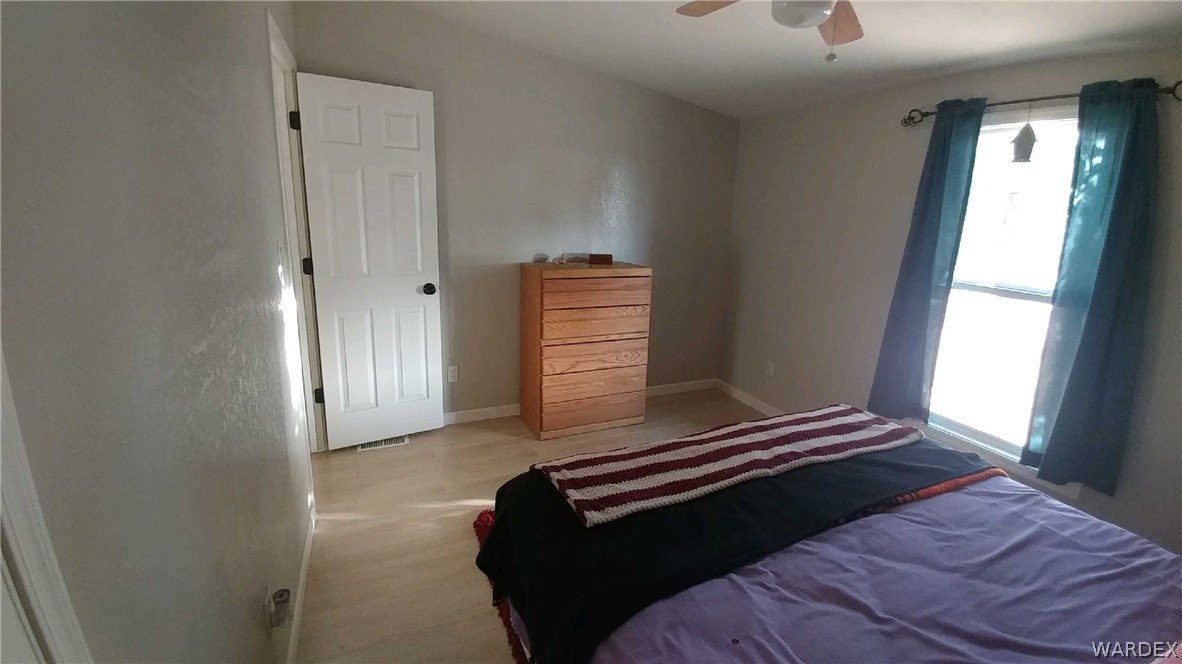 3634 Bibo Road Golden Valley, AZ 86413 - Photo 13 of 44 a bedroom with a bed and a window