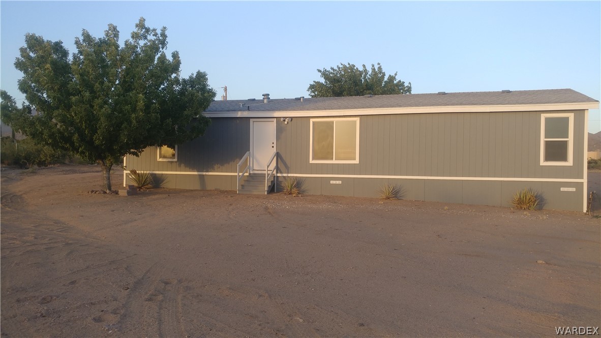3634 Bibo Road Golden Valley, AZ 86413 - Photo 15 of 44 front view of a house with a street