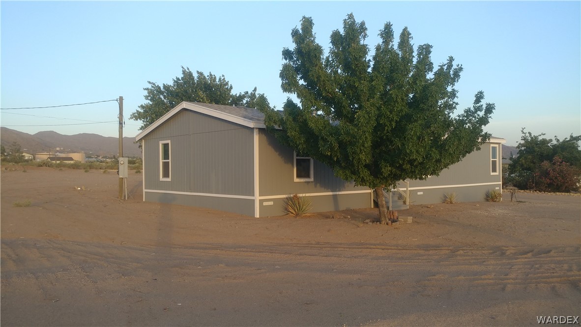 3634 Bibo Road Golden Valley, AZ 86413 - Photo 2 of 44 a view of a house with a yard
