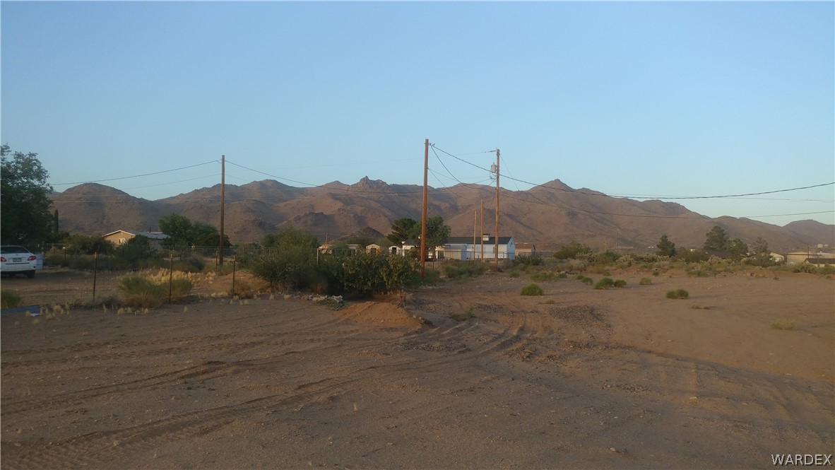 3634 Bibo Road Golden Valley, AZ 86413 - Photo 23 of 44 a view of a dry field with mountains in the background
