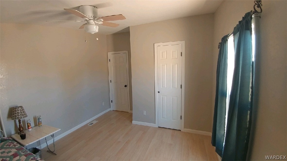 3634 Bibo Road Golden Valley, AZ 86413 - Photo 26 of 44 a view of a room with a chandelier fan and closet area