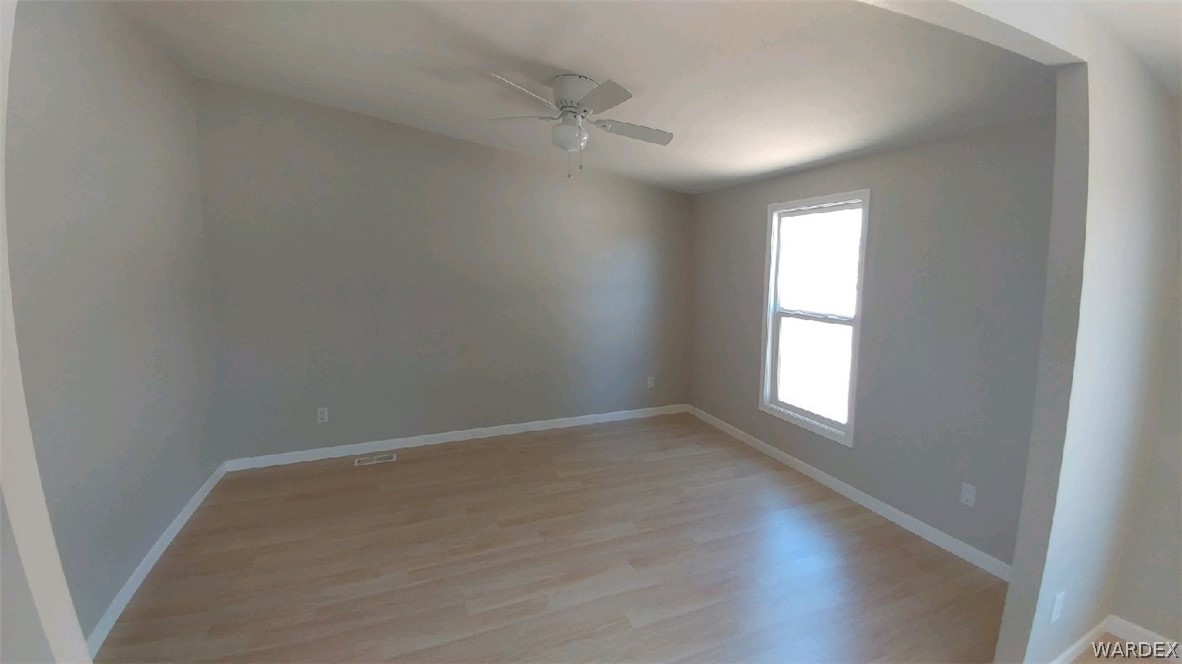 3634 Bibo Road Golden Valley, AZ 86413 - Photo 29 of 44 an empty room with wooden floor and windows
