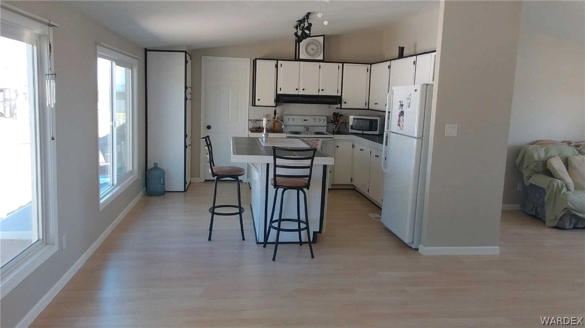 3634 Bibo Road Golden Valley, AZ 86413 - Photo 6 of 44 a kitchen with a refrigerator a stove a sink and a cabinets