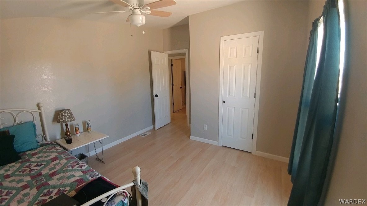 3634 Bibo Road Golden Valley, AZ 86413 - Photo 10 of 44 a bedroom with a bed and a chandelier