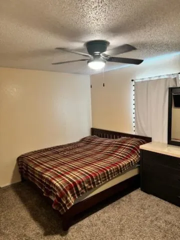 a bed sitting in a bedroom next to a window