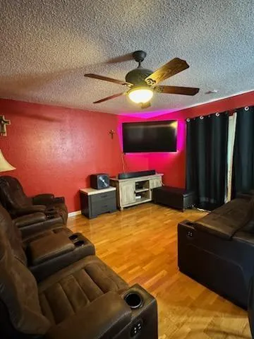 a living room with furniture pool table and a fireplace