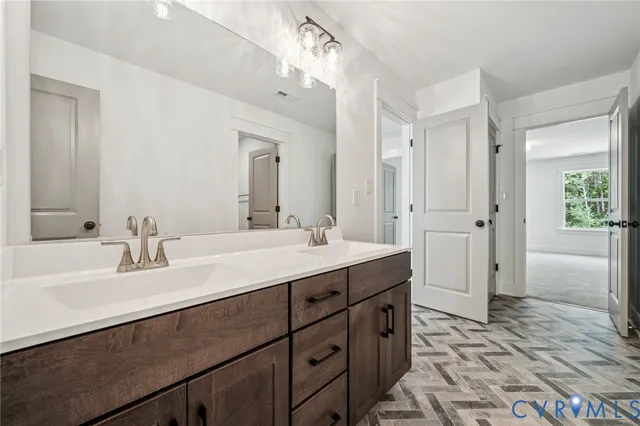 a bathroom with a sink double vanity granite tub shower and a mirror
