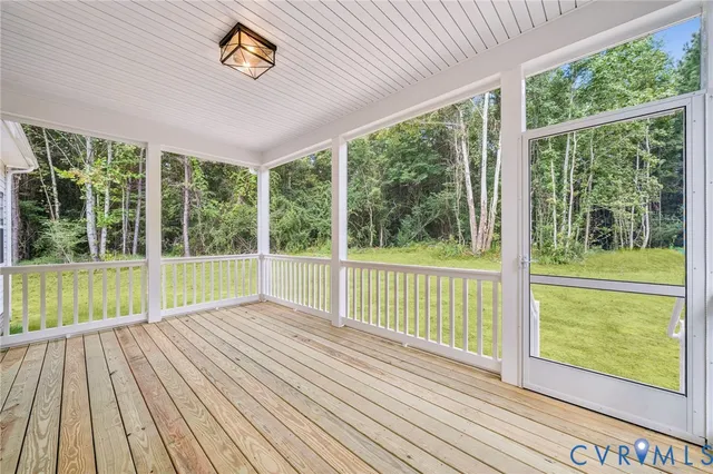 a view of a room with wooden floor and windows