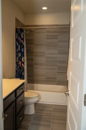 a bathroom with a shower curtain and a sink