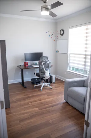 a view of a workspace with furniture and a window