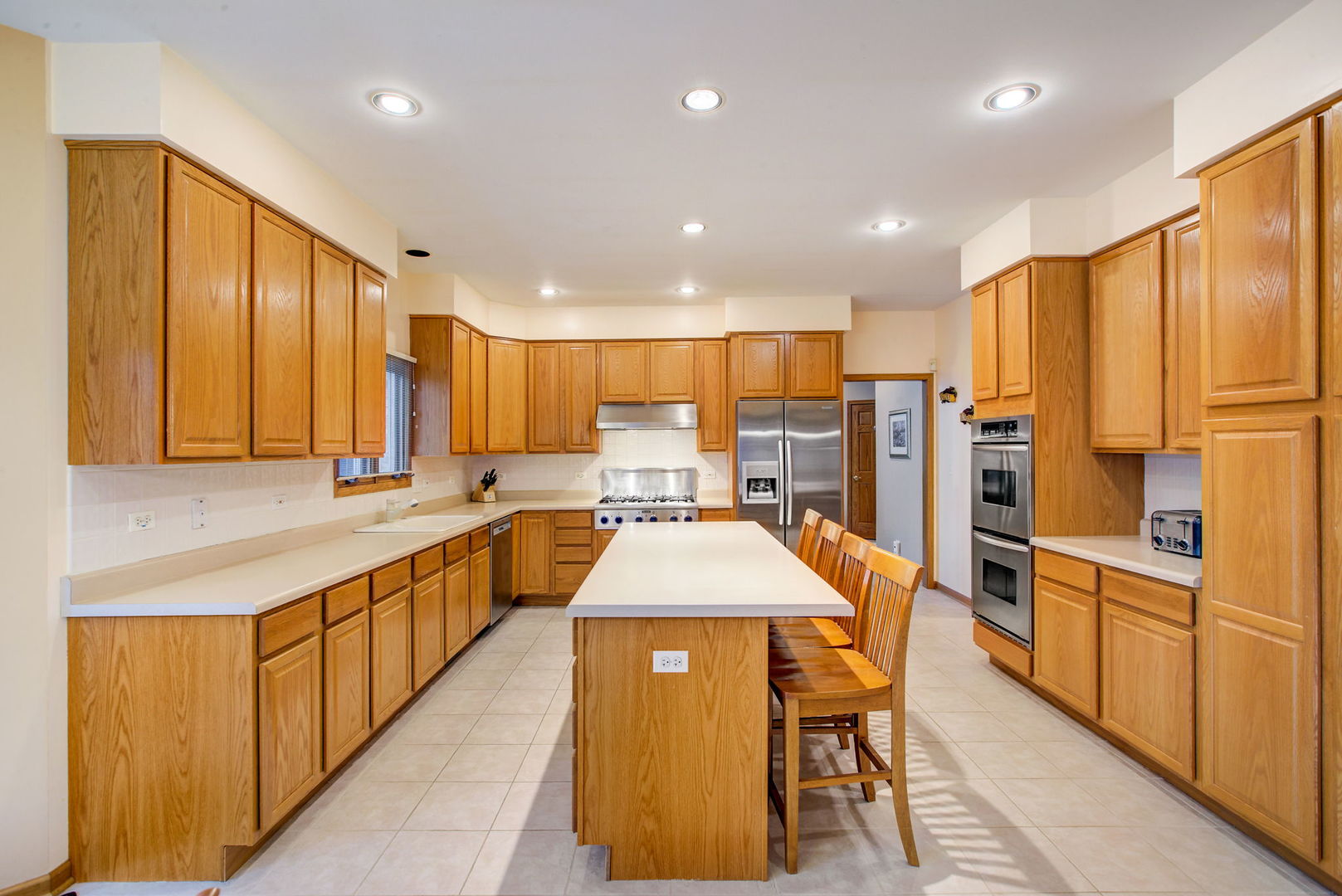 206 Meier Road Arlington Heights, IL 60005 - Photo 15 of 42 a large kitchen with stainless steel appliances kitchen island granite countertop a large counter top stainless steel appliances and cabinets