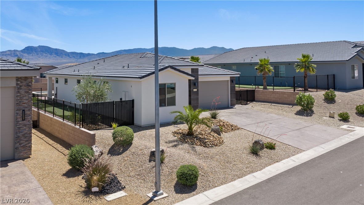 1436 Manassas Ridge Mesquite, NV 89027 - Photo 71 of 77 A desert-friendly landscape surrounds this contemporary residence, offering mountain views and private outdoor spaces.