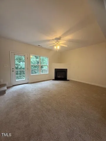 a view of a big room with an empty space and a window